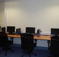 school desks with chairs and computers