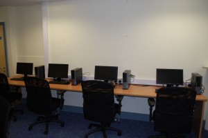 school desks with chairs and computers