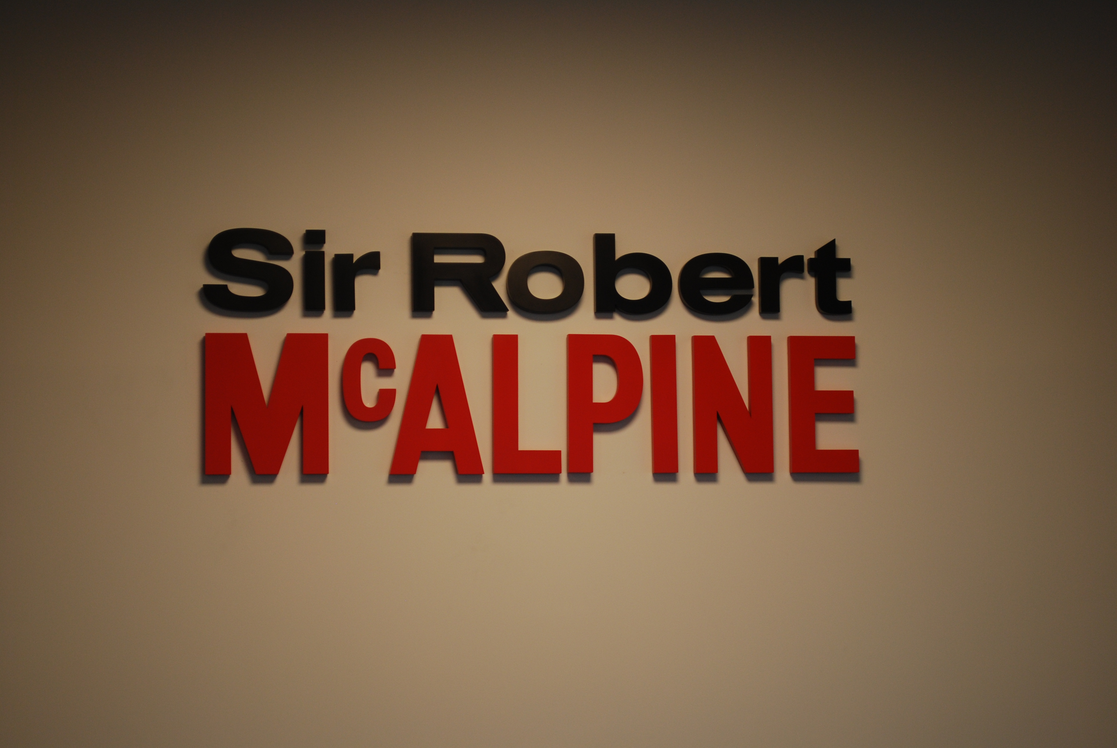 Sir Robert McAlpine banner on brown background