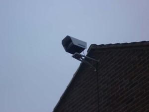 Installed CCTV camera outside the top of a wall