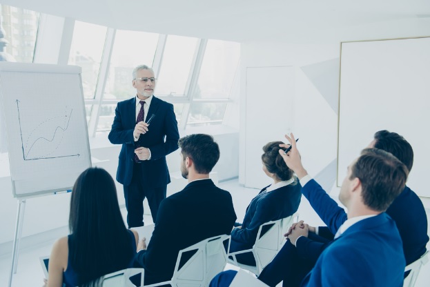 A man uses outdated audio visual solution in front of a class or team