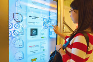 Woman using an interactive digital signage at a shopping mall