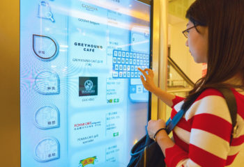 Woman using an interactive digital signage at a shopping mall