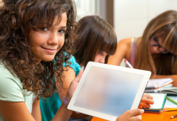 Young Teenage girl holding interactive screens for schools in a classroom environment